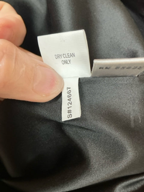 Dry clean only care label and style number S#124667 for Kay Unger New York black floral cocktail dress, confirming garment maintenance details.