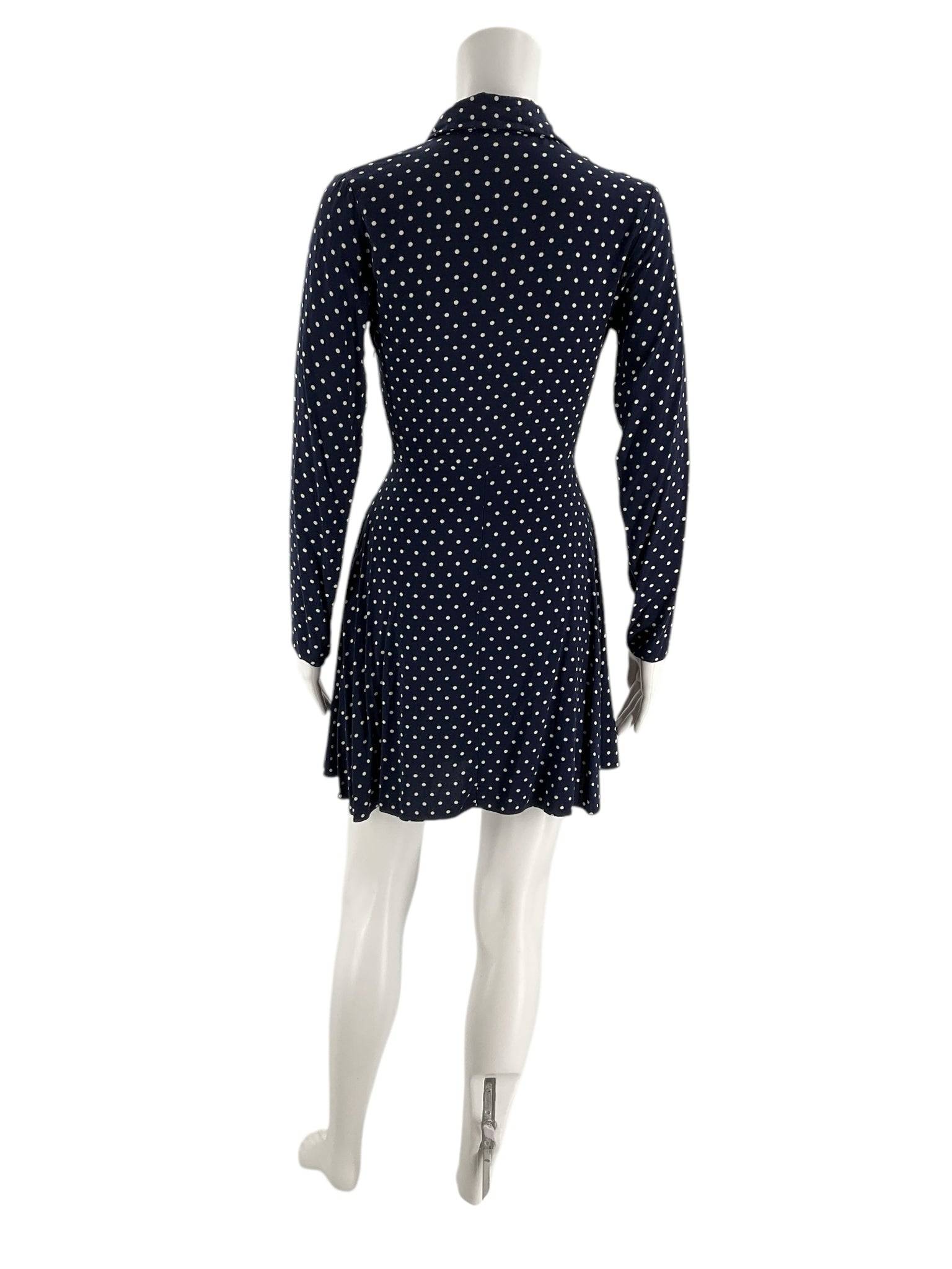 Back view of ASOS navy polka dot dress size 2, showcasing long sleeves and flared hem, available pre-owned at Margaret's Fine Consignments.