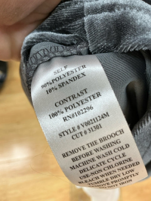 Close-up of fabric care label on Connected Apparel gray velour dress, showing polyester-spandex blend and washing instructions.