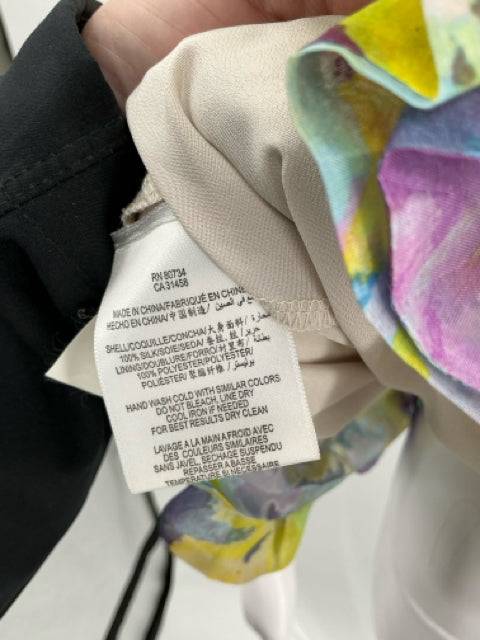 Close-up of care label on BCBG Blue/Yellow/Purple Dress Size 2 showing fabric content and washing instructions, listed at Margaret’s Fine Consignments.