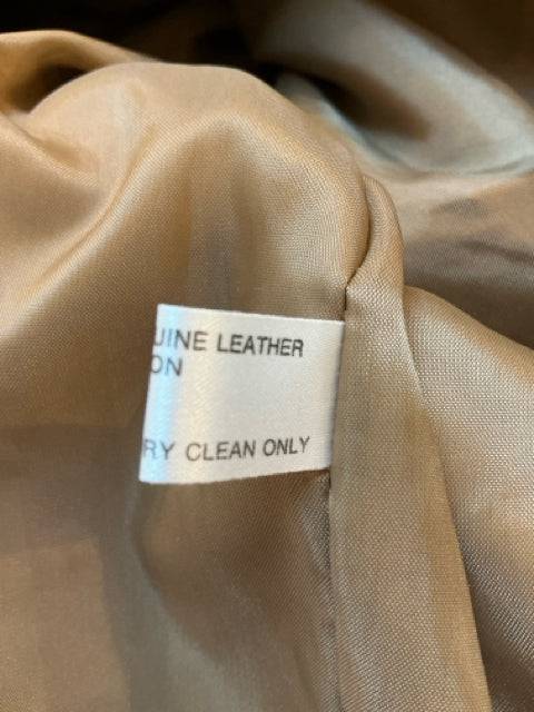Fabric care tag on Orvis Taupe Leather Jacket Size Large indicating genuine leather material and professional dry clean instructions.