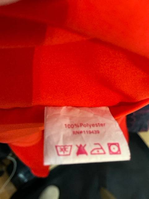 Garment care label showing 100% polyester fabric and care instructions for Julie Brown Dress Size 4. Shop luxury fashion at Margaret’s Fine Consignments.