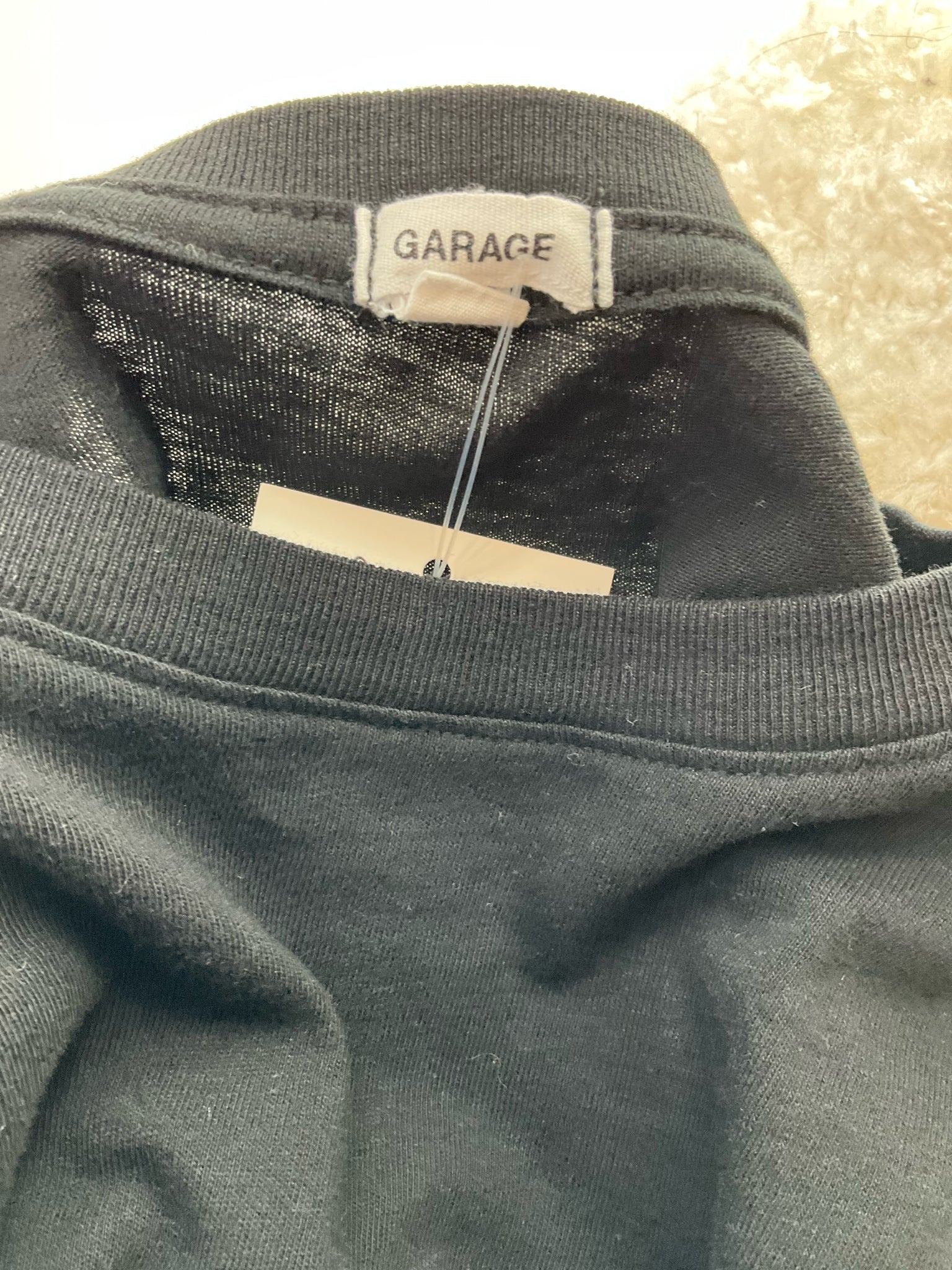 Cropped long sleeve black graphic tee with crew neck from Garage, featuring an edgy Y2K design for ladies, size XS.