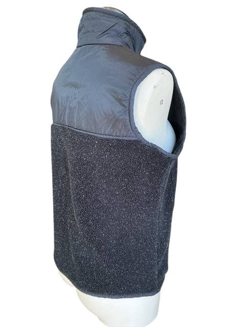 Back angled view of Gap Vest Size Small highlighting nylon upper and fleece lower sections. Sustainable outerwear from Margaret’s Fine Consignments.