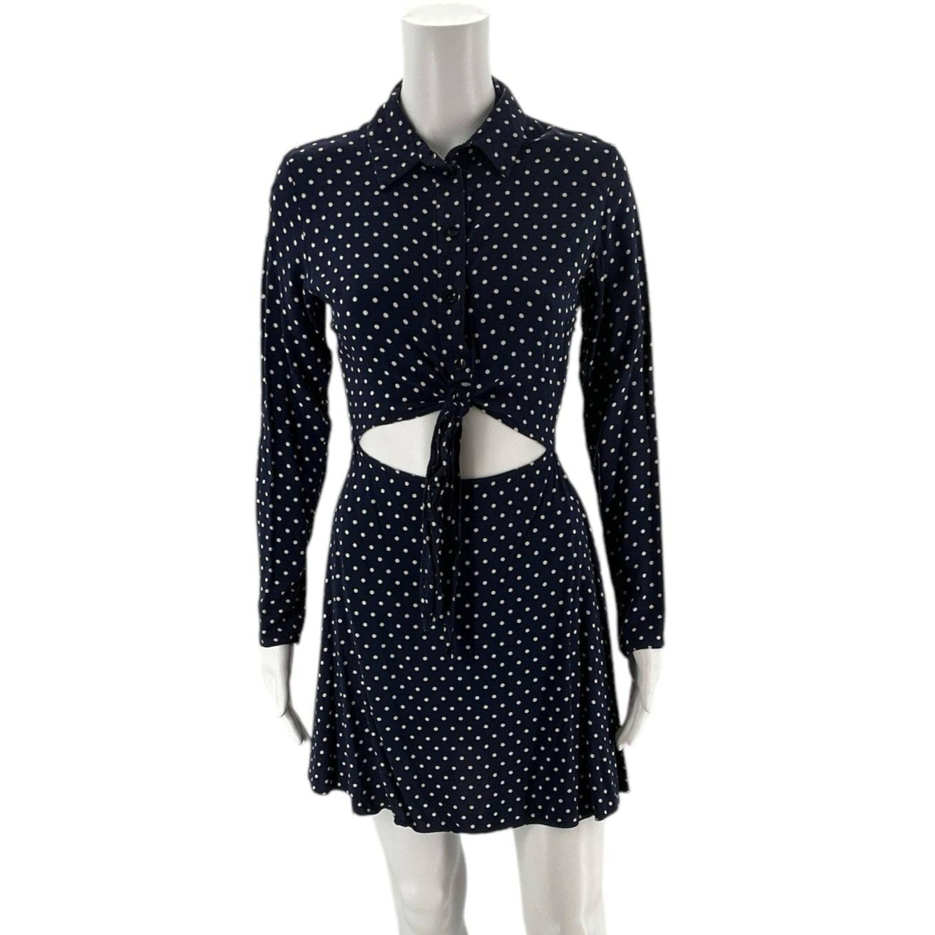 Front view of ASOS Dress Size 2 in navy with white polka dots, featuring long sleeves, cutout waist, and tie-front design at Margaret's Fine Consignments.