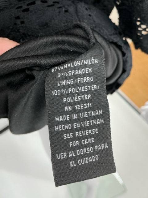 Fabric tag of Ronni Nicole Black Eyelet Dress Size 12 showing nylon, spandex, and polyester materials, made in Vietnam.