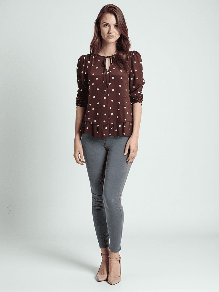 Loft Top Size S in maroon with pink polka dots, long sleeves, and keyhole neckline, modeled with gray skinny pants at Margaret's Fine Consignments.