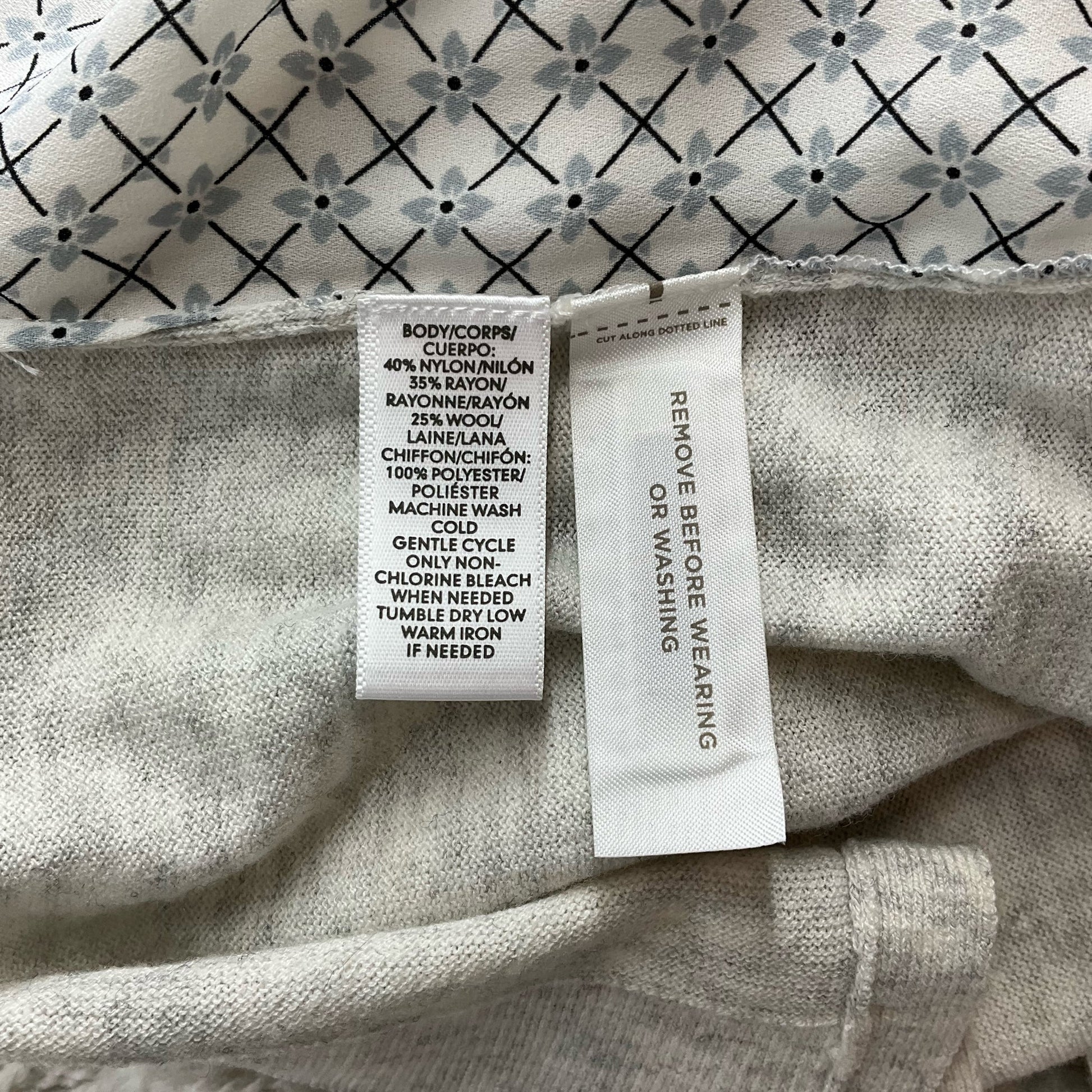 Fabric care label of Loft Gray Solid New with Tag Pre-Owned Top - Size Small detailing material composition and washing instructions.