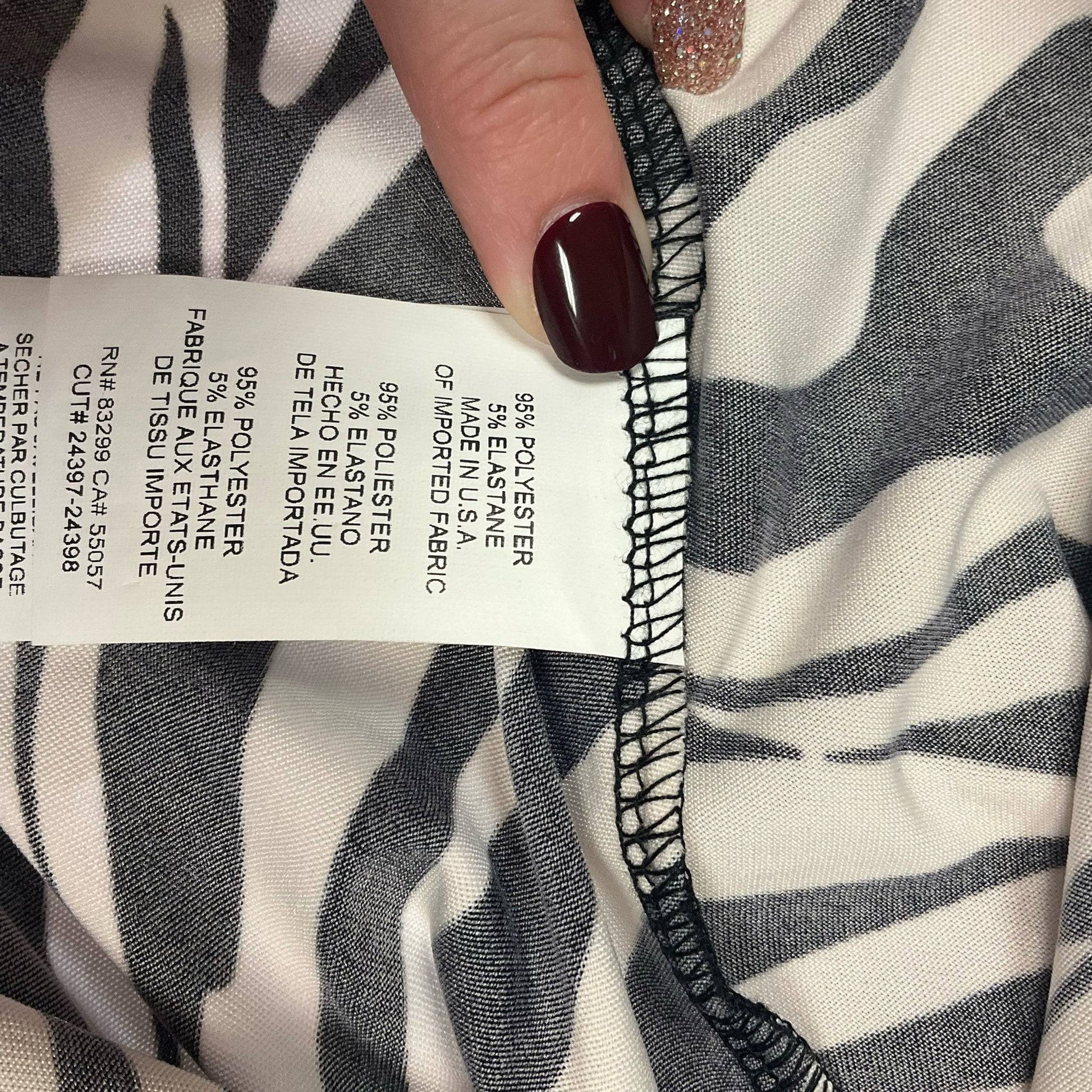 Fabric content tag showing 95% polyester and 5% spandex blend on Tiana B. zebra print dress, size medium.