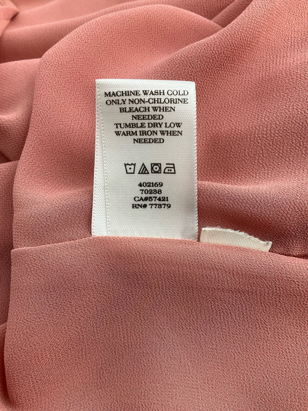 Salmon sleeveless Ann Taylor blouse with high-low hem, size XL, showcasing a stylish swing top design.