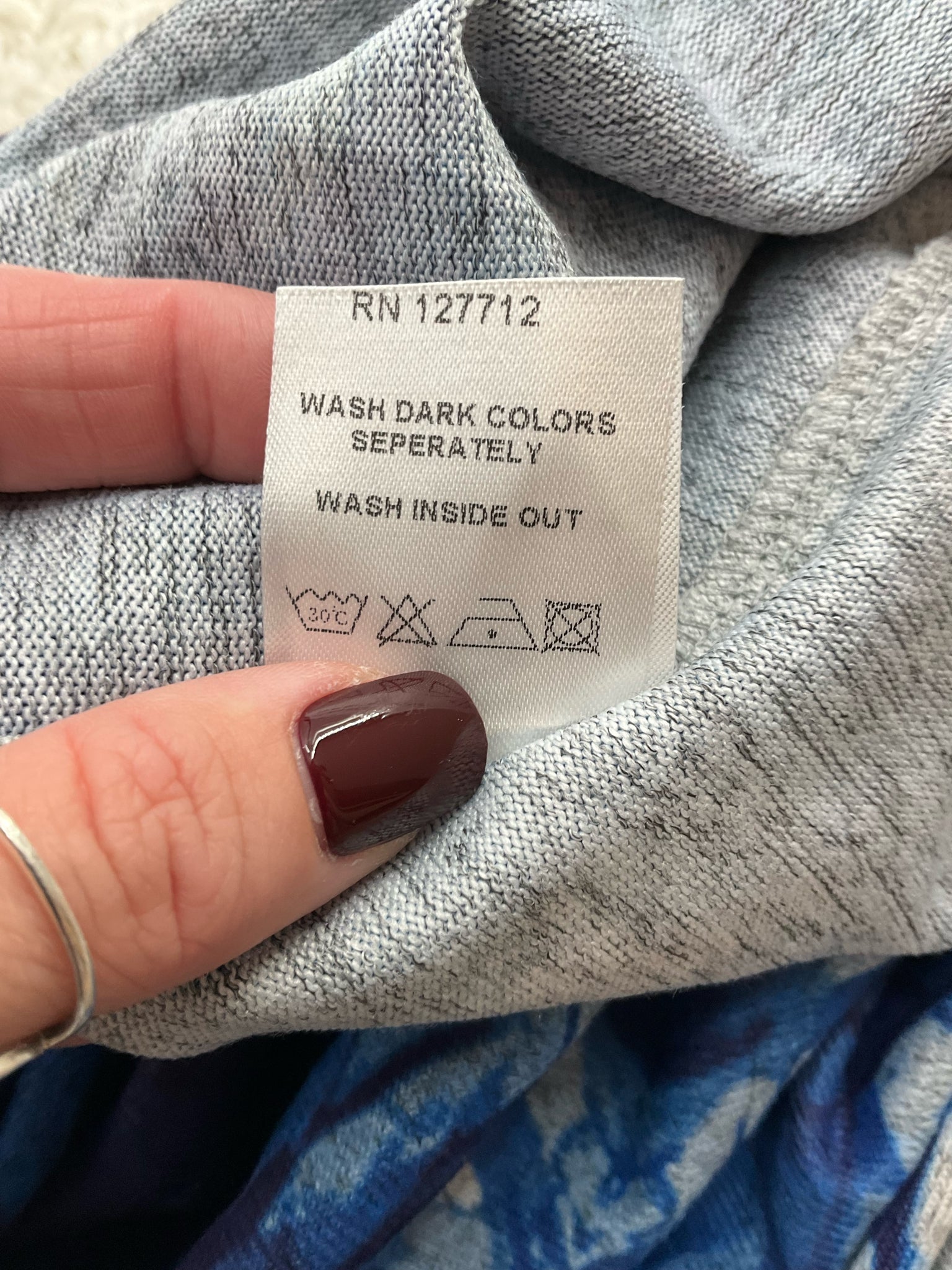 Miss Nikky blue print long sleeve tunic top, casual V-neck design, pre-owned, size small, with stretch fabric.