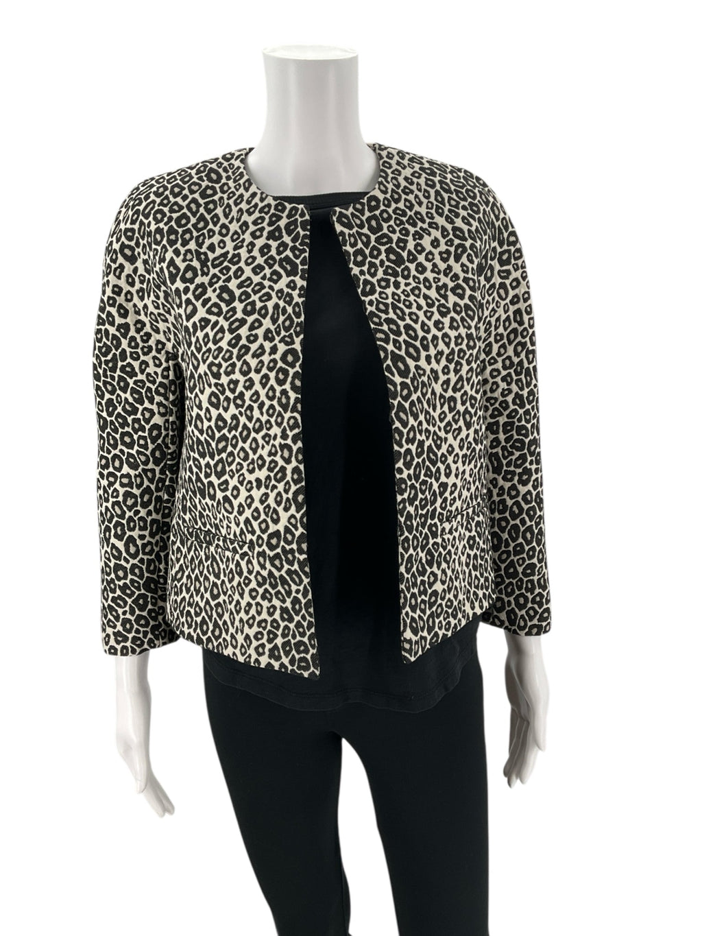 Angled front view of Ann Taylor Cream/Black Animal Pre-Owned Jacket - Size XS on mannequin, showcasing structured fit and animal print design.