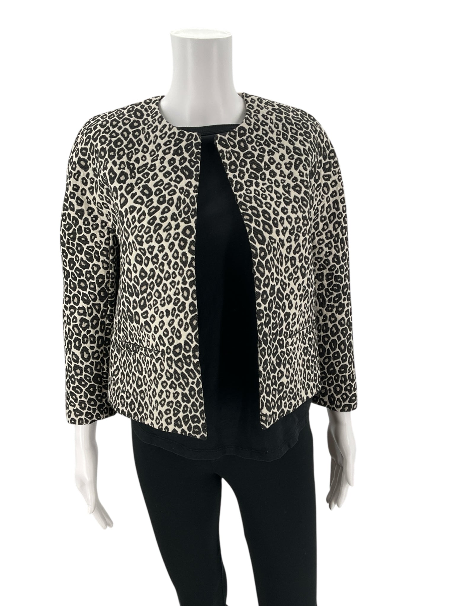 Angled front view of Ann Taylor Cream/Black Animal Pre-Owned Jacket - Size XS on mannequin, showcasing structured fit and animal print design.