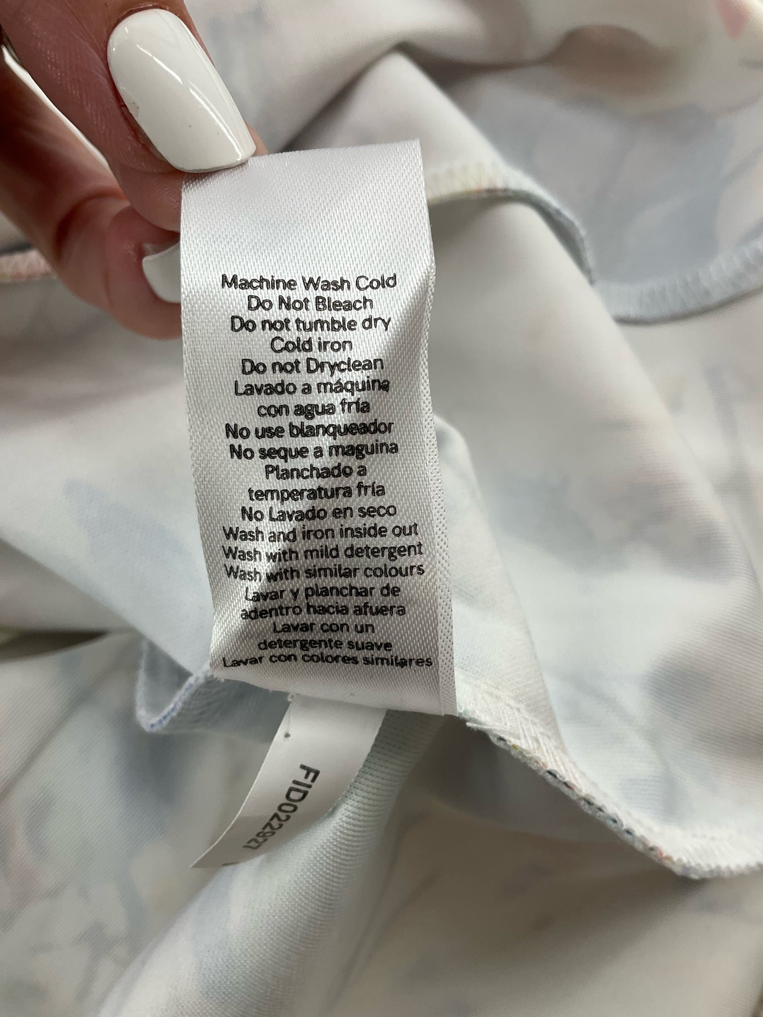 Care label of Venus Watercolor Floral Halter Dress with washing instructions including machine wash cold and no tumble dry.