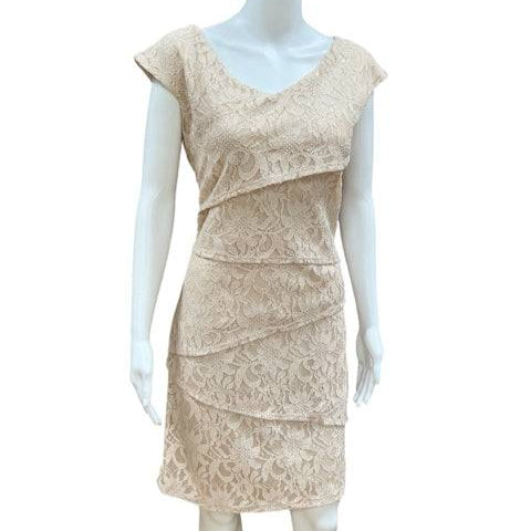 Champagne lace Ronni Nicole Dress Size 10 displayed on a mannequin with tiered layers and V-neck. Shop at Margaret's Consignments.