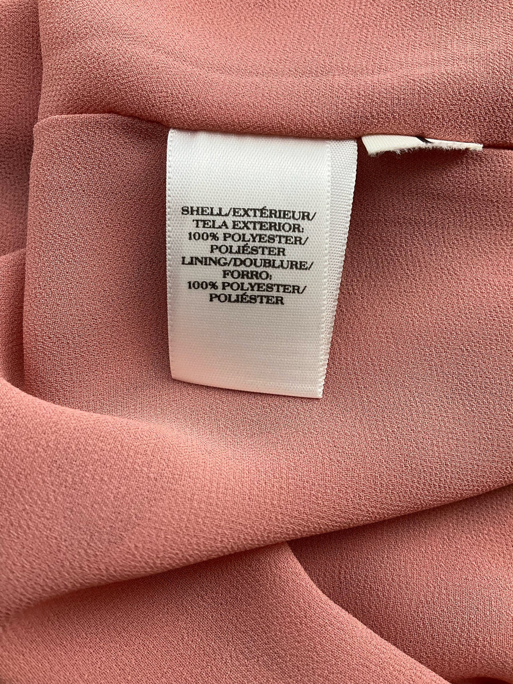 Ann Taylor salmon sleeveless blouse with high-low hem, size XL, featuring a swing top design.