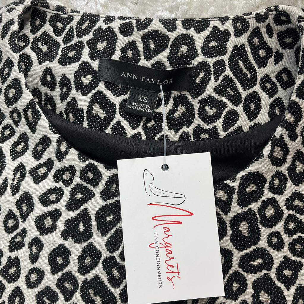 Close-up of Ann Taylor label and Margaret’s Fine Consignments tag on Cream/Black Animal Pre-Owned Jacket - Size XS.
