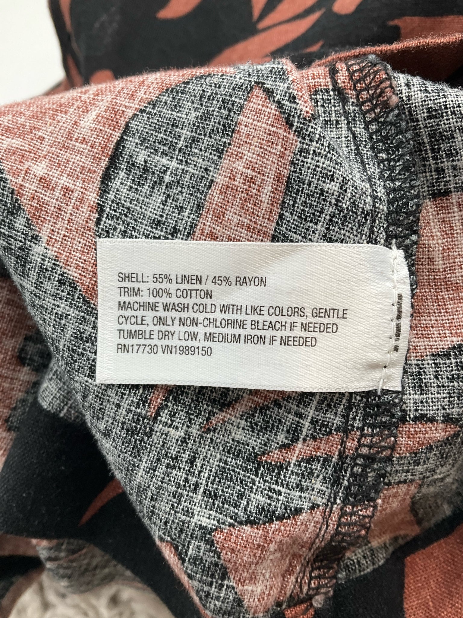 A New Day brown and black print sleeveless mini shift dress, size small, with tags attached, featuring an A-line silhouette.