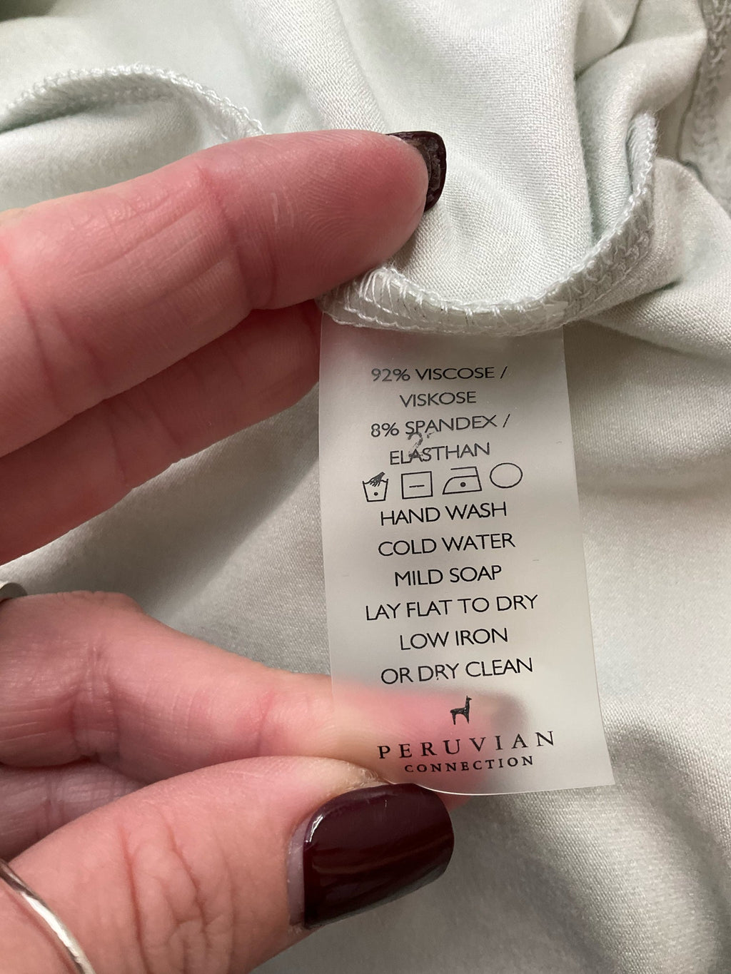 Mint green scoop neck tank top from Peruvian Connection, sleeveless A-line design, size large, pre-owned condition.