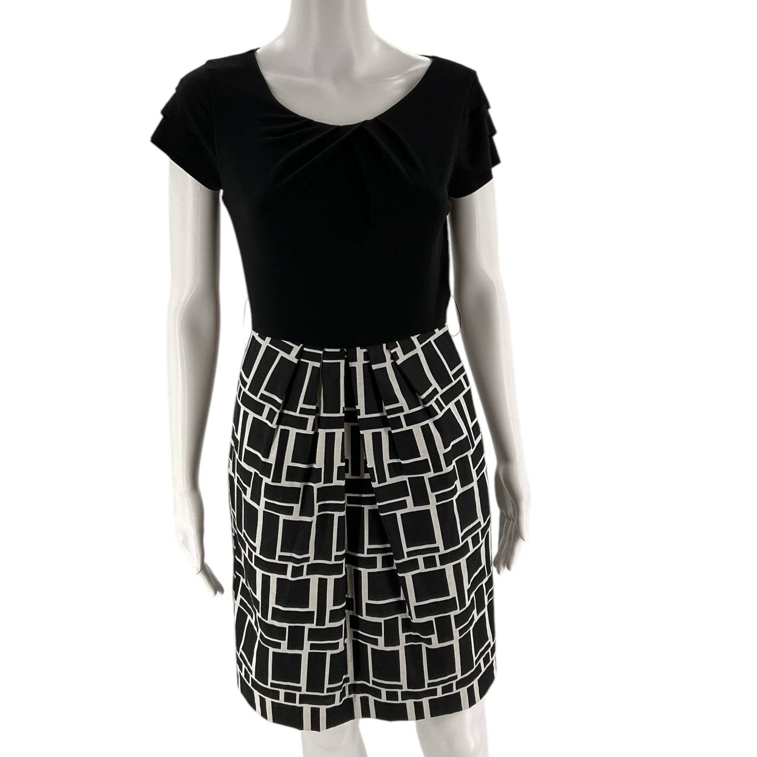 Front view of Max and Cleo Dress Size 4 on mannequin, featuring black top and cream geometric mini skirt at Margaret's Fine Consignments.