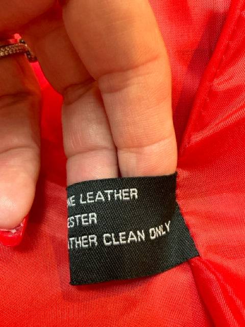 Detailed fabric tag of Excelled Orange Leather Jacket Size XL indicating genuine leather material and professional leather clean only.