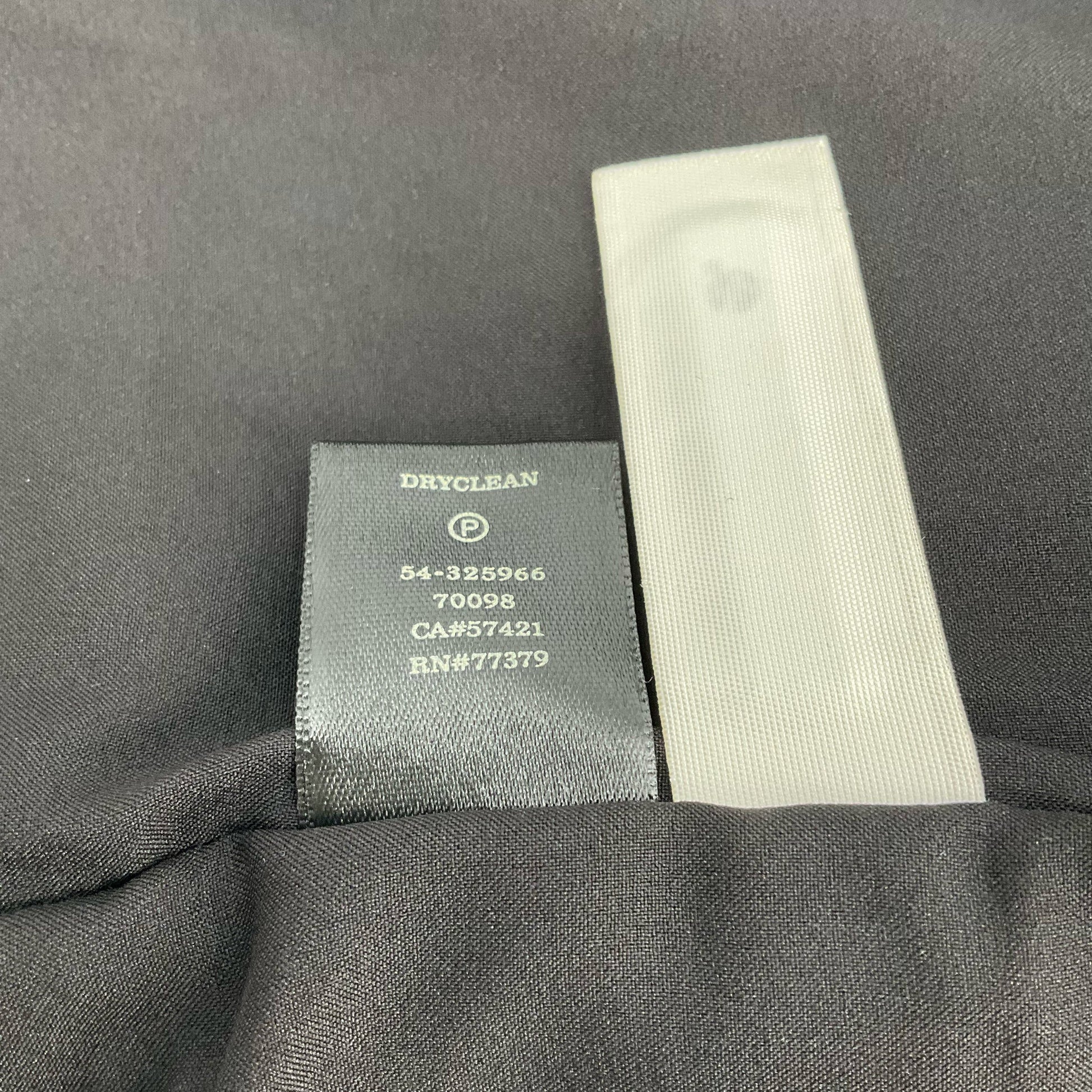 Care label of Ann Taylor Cream/Black Animal Pre-Owned Jacket - Size XS, indicating dry clean only instructions and product codes.