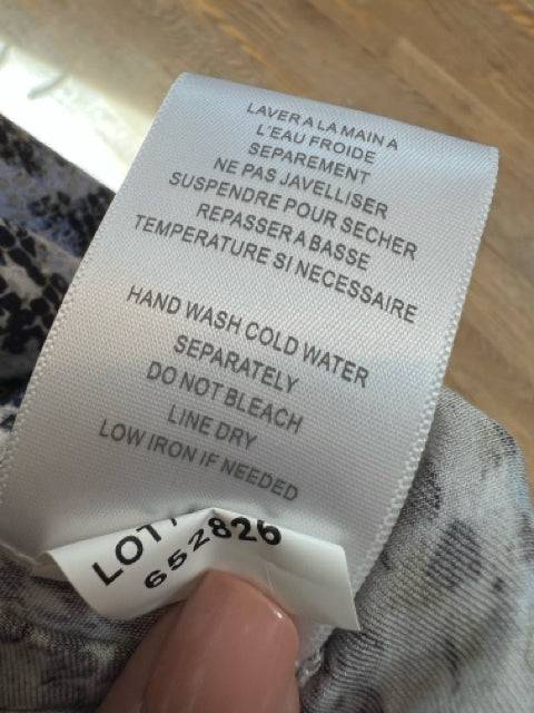 Care label for Tribal Dress Size Large with hand wash instructions, emphasizing gentle care for long-lasting wear.