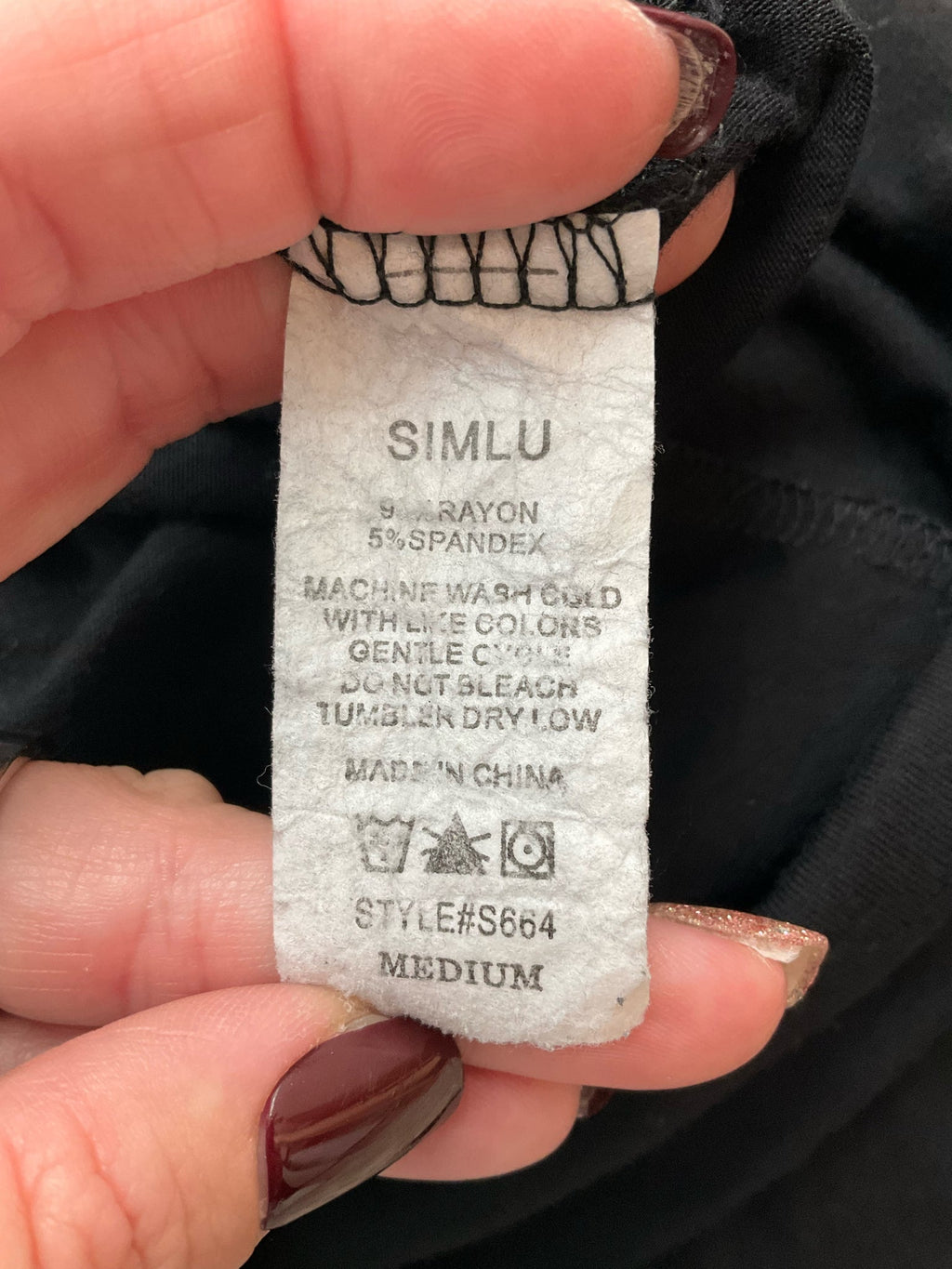 Simlu black solid pre-owned ladies batwing top in size medium, featuring a casual dolman style and tunic length.