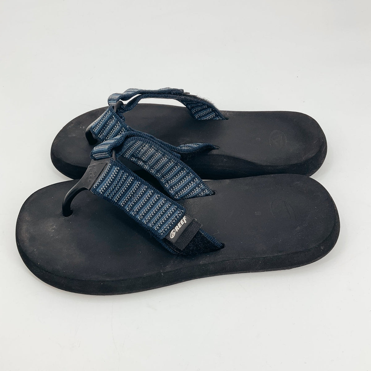 Reef women's navy & gray striped flip flop sandals in size 8 with black EVA footbed and webbing strap, ideal for beach or casual wear.