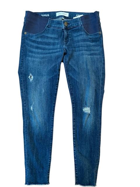 Flat lay of dl1961 Maternity Jeans Size 5 in dark blue with ripped accents and stretchy waistband. Shop pre-loved denim at Margaret’s Fine Consignments.