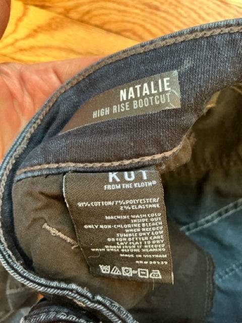 Interior label of Kut Jeans Size 0 showing 'Natalie High Rise Bootcut' style and fabric care details for informed purchase.