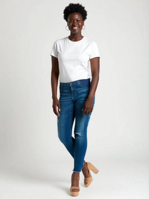 dl1961 Maternity Jeans Size 5 styled on model with white tee and heels, featuring dark blue wash and ripped detailing. Available at Margaret’s Fine Consignments.