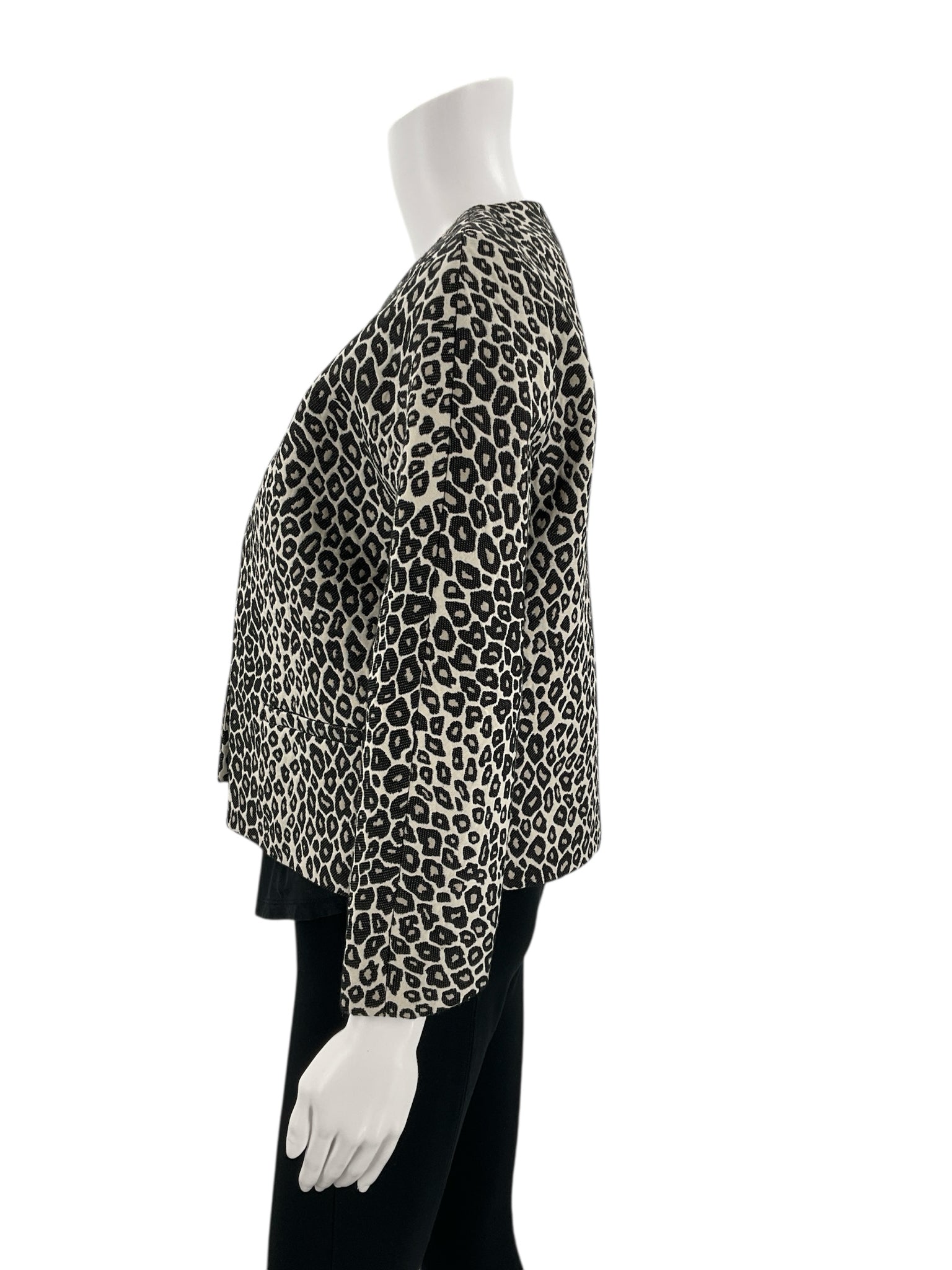 Side profile of Ann Taylor Cream/Black Animal Pre-Owned Jacket - Size XS on mannequin, showing sleeve length and tailored shape.