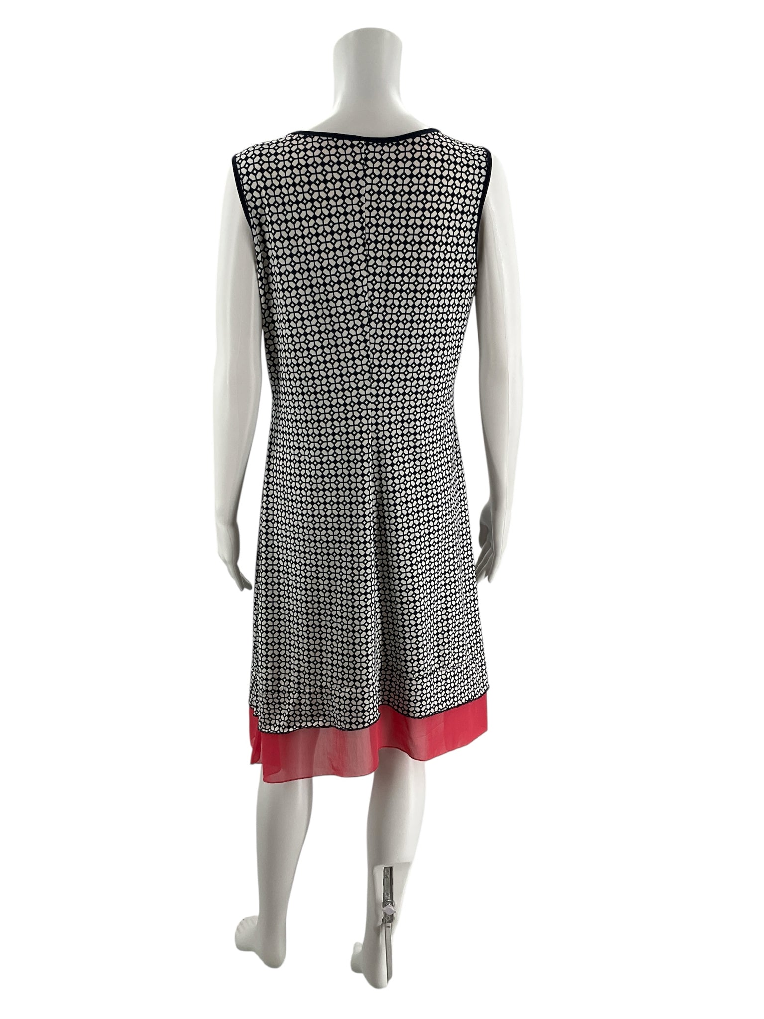 Back view of Perception Concept Navy/White Print Pre-Owned Ladies Dress - Size Medium with navy and white mosaic print and coral layered hem.
