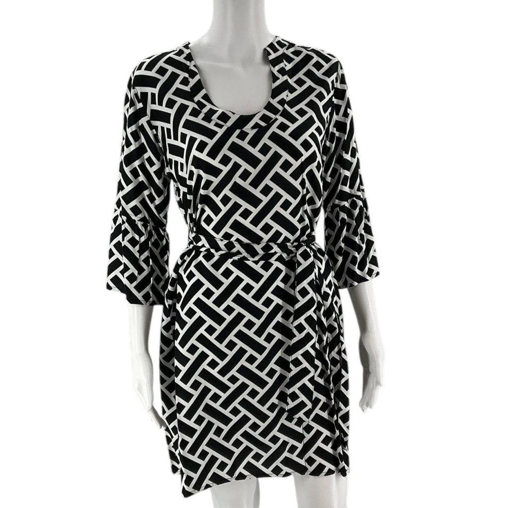 Front view of Escapada Dress Size Small with black and white print, featuring a belted waist and flared sleeves, new with tags.