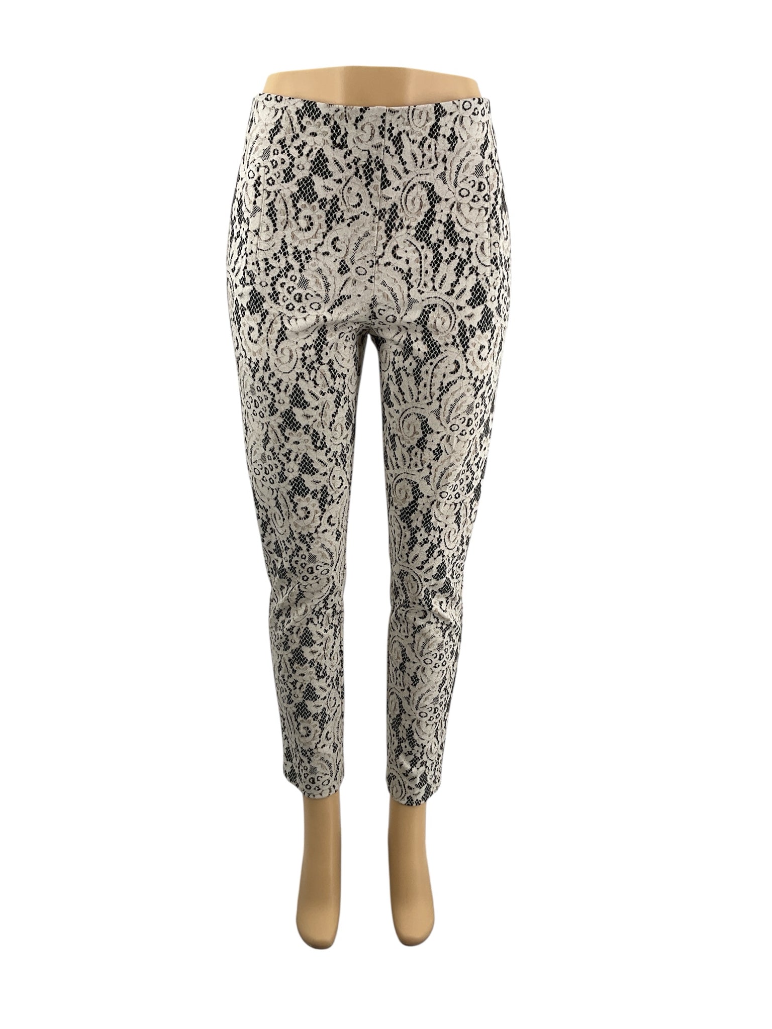Chico's cream and black lace pull-on ankle pants, tapered leg, stretch knit, size small, displayed on a neutral background.