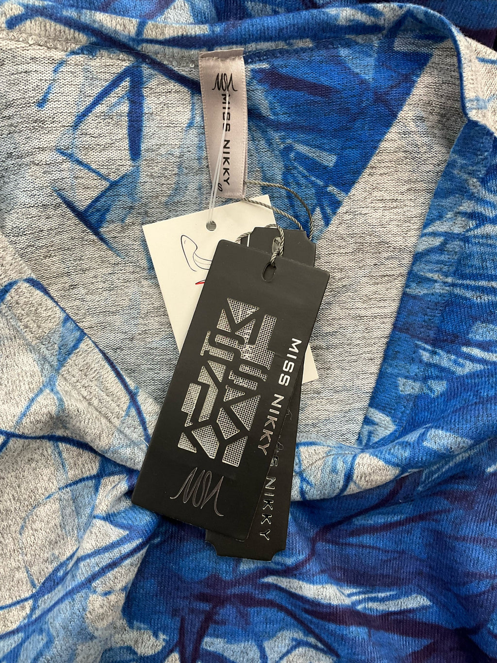 Miss Nikky blue print long sleeve tunic top in size small with a V-neck and casual pullover design.