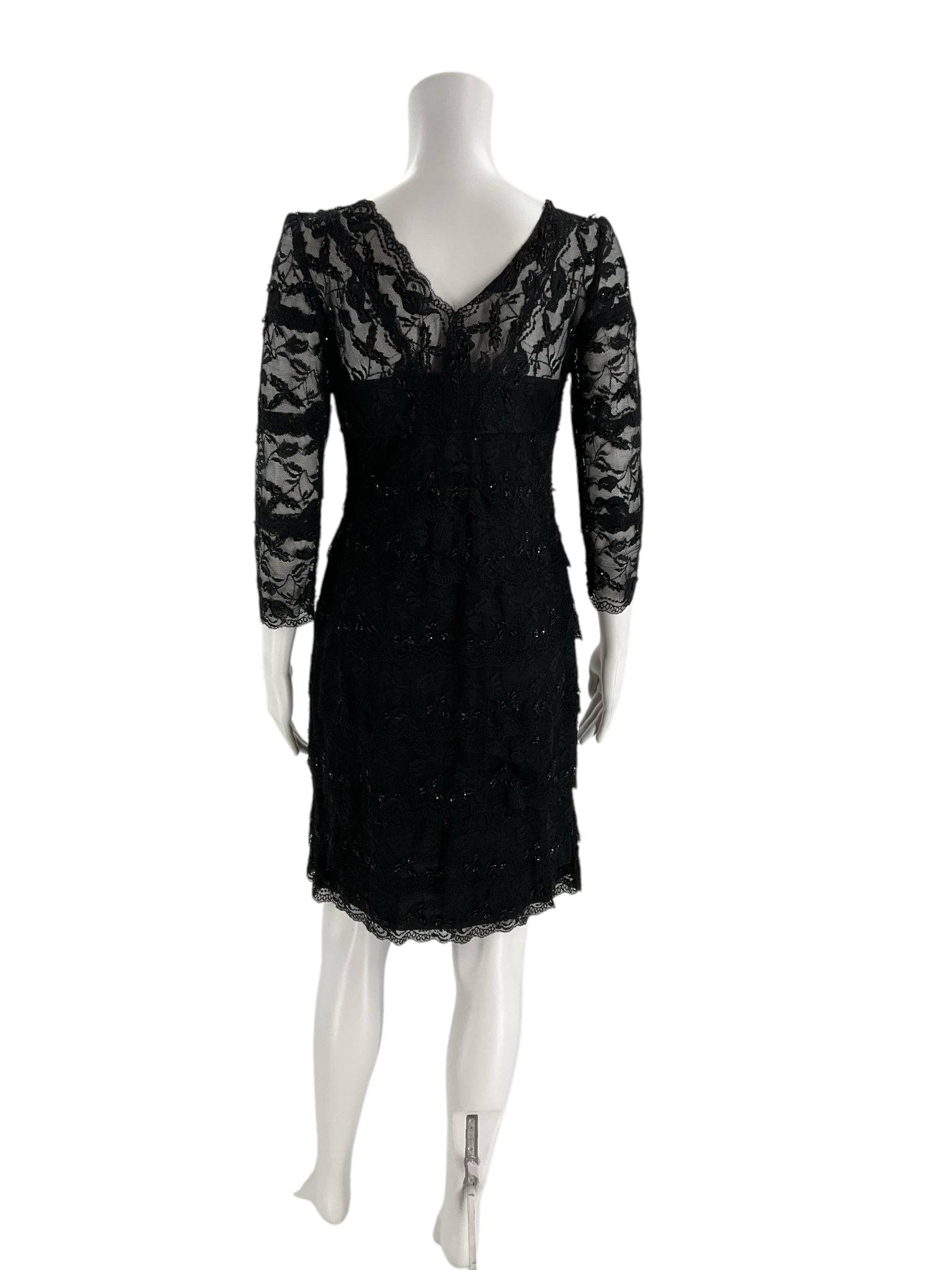 Back view of Marina Dress Size 10 Petite featuring sheer black lace and scalloped hem, sold by Margaret's Fine Consignments.
