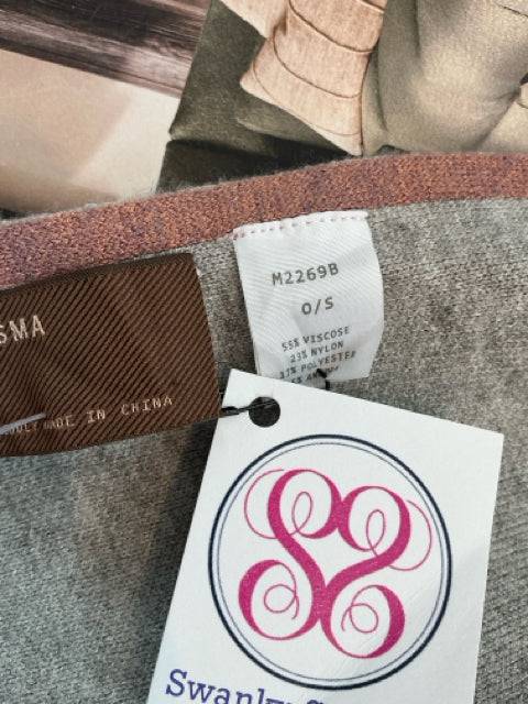 Close-up of Kerisma Shrug tags showing fabric blend and size O/S, featured at Margaret’s Fine Consignments.