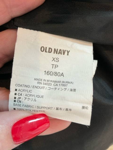 Close-up of Old Navy Vest Size XS label showing material details and manufacturing origin, confirming authenticity and size.