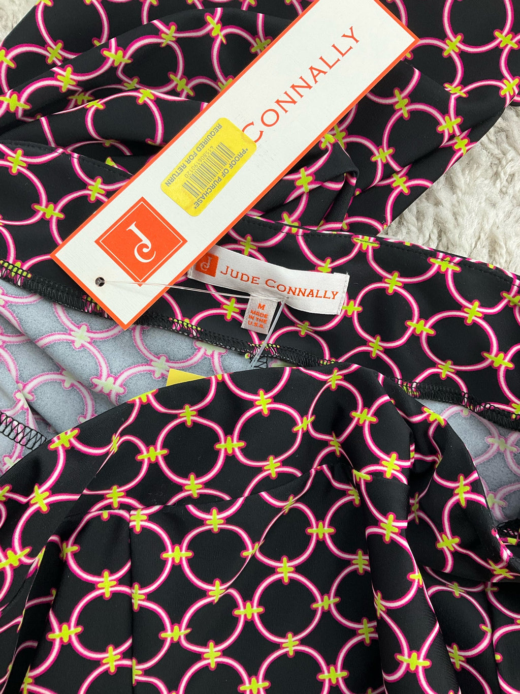 Jude Connally pre-owned cropped pants in black, pink, and green print, slim leg style, size medium, pull-on ankle design.