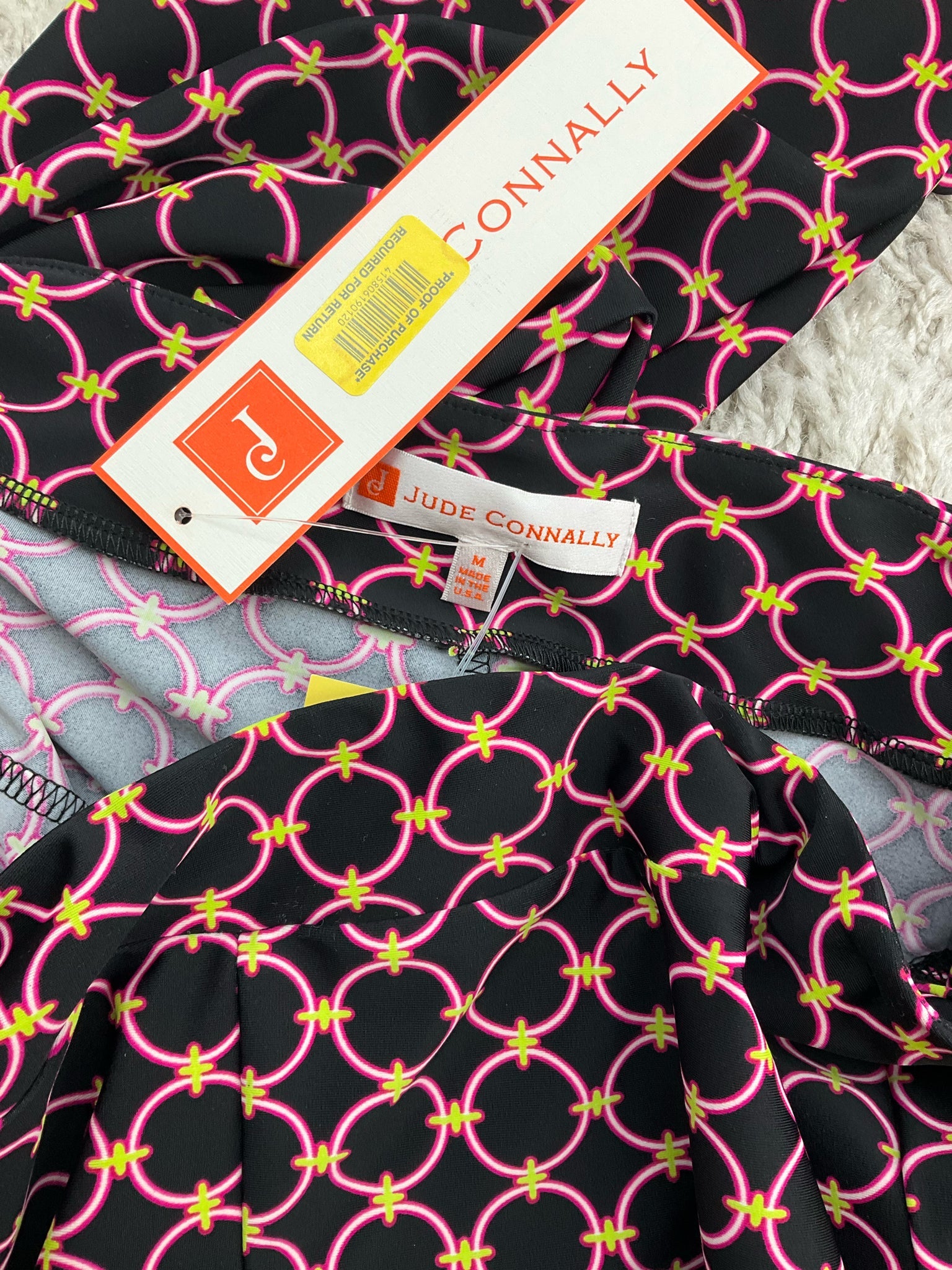 Jude Connally pre-owned cropped pants in black, pink, and green print, slim leg style, size medium, pull-on ankle design.