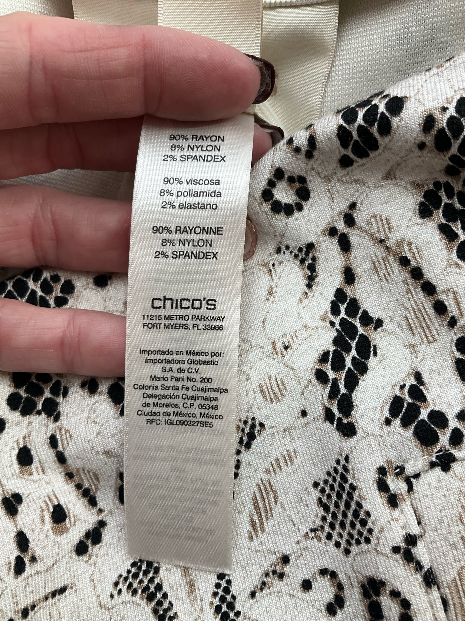 Chico's cream and black lace pull-on ankle pants, tapered leg design, size small, showcasing stretch knit fabric.