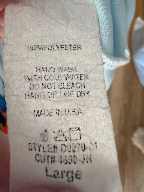Fabric care label of Peach Love Dress Size Large showing polyester material and washing instructions, confirming U.S. origin.