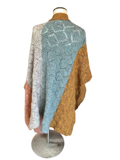 Back view of Sundance Shrug Size XS/S on mannequin, showing intricate knit texture and colorblock layout. Available at Margaret’s Fine Consignments.
