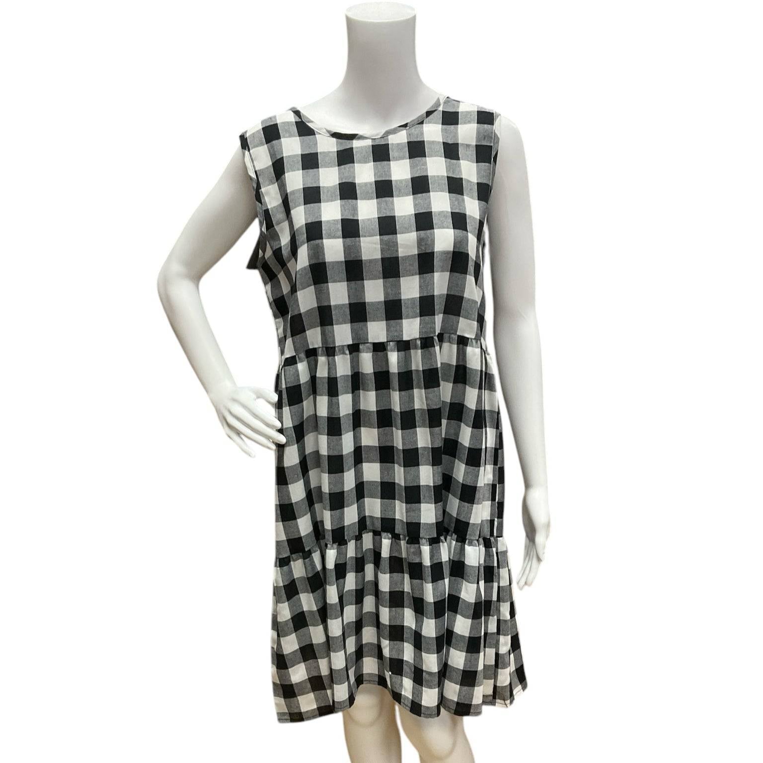 This & That Black/White Checkered Dress Size Small displayed on mannequin, sleeveless with gathered waist and flared hem, new with tags.