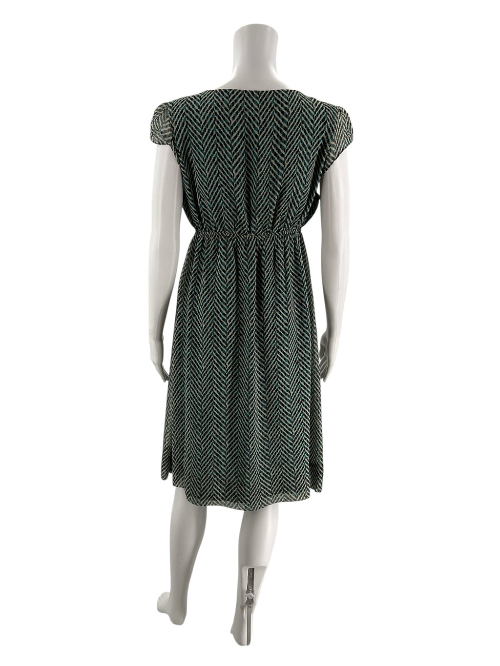 Back view of New York & Co teal and cream empire waist dress, showing herringbone pattern and gathered waist detail on mannequin.