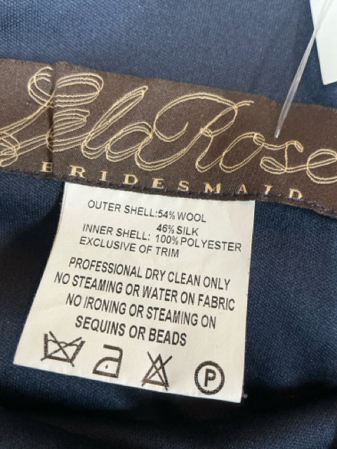 Close-up of Lela Rose bridesmaid dress label showing fabric composition of 54% wool and 46% silk, with care instructions for dry cleaning only.