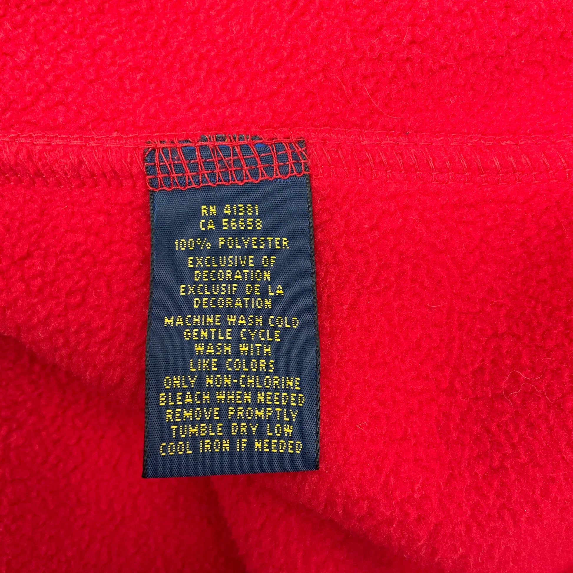 Care tag of Polo Red Fleece Vest Size Medium showing fabric and wash instructions. Available at Margaret’s Fine Consignments.