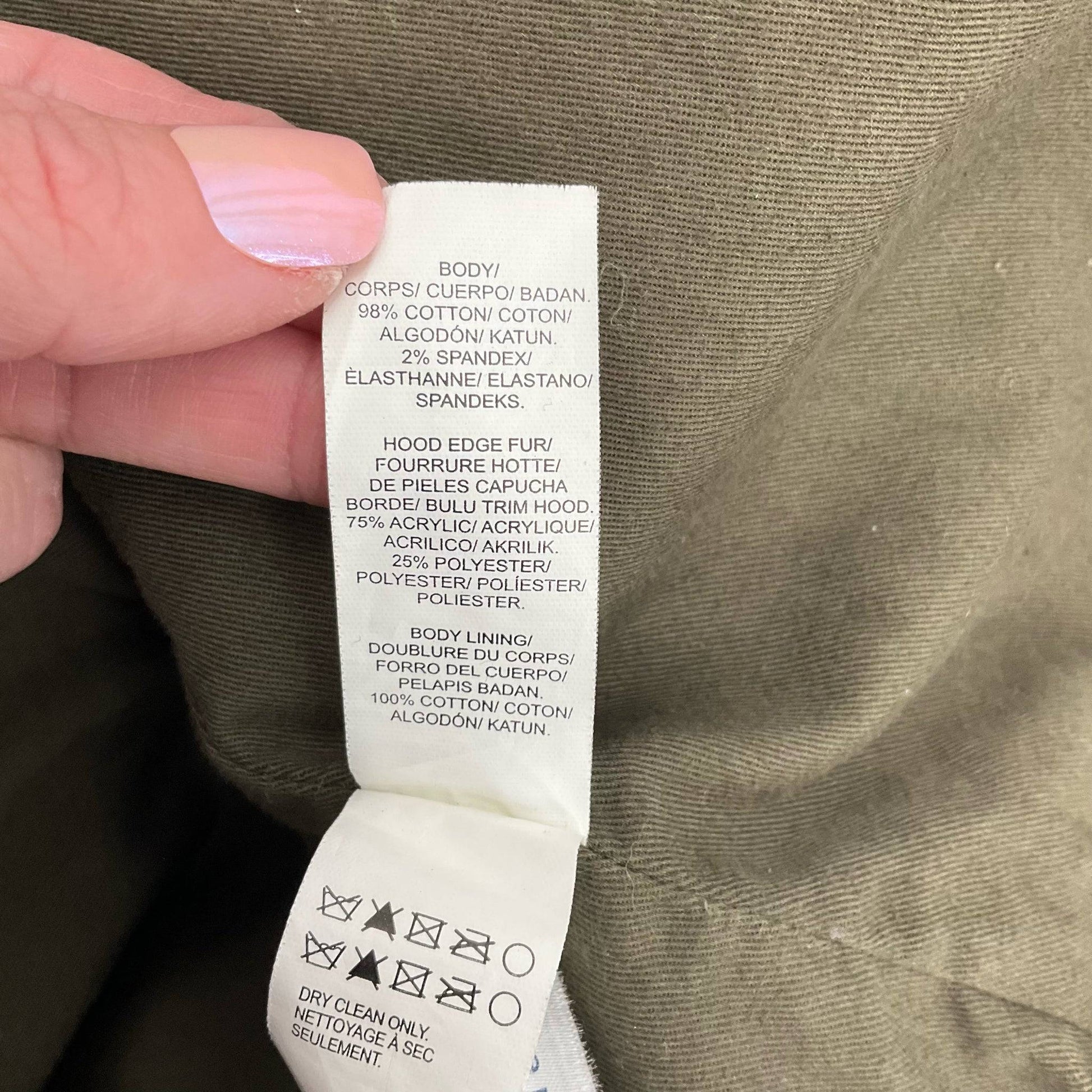 Fabric content and care label of Lucky Brand Olive Solid Jacket – Size XS showing cotton-spandex blend and faux fur hood details.